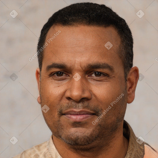 Joyful latino adult male with short  black hair and brown eyes
