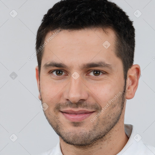 Joyful white young-adult male with short  brown hair and brown eyes