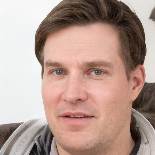 Joyful white adult male with short  brown hair and grey eyes