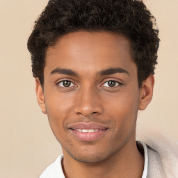 Joyful black young-adult male with short  brown hair and brown eyes