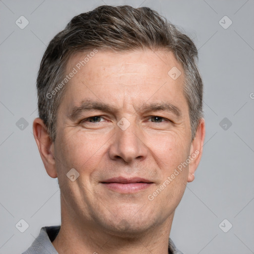 Joyful white adult male with short  brown hair and grey eyes