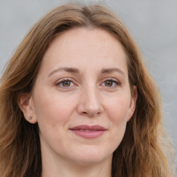 Joyful white adult female with long  brown hair and brown eyes