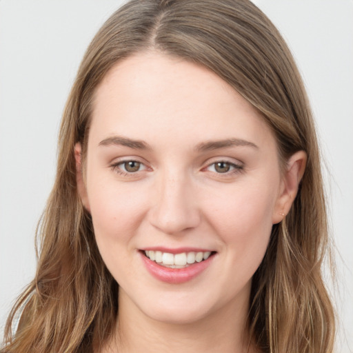 Joyful white young-adult female with long  brown hair and grey eyes