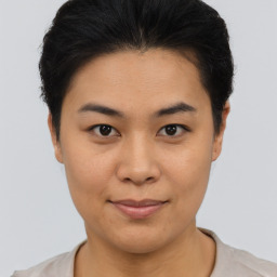 Joyful asian young-adult female with short  brown hair and brown eyes