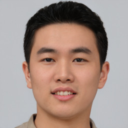 Joyful asian young-adult male with short  black hair and brown eyes