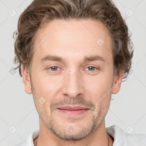 Joyful white adult male with short  brown hair and grey eyes