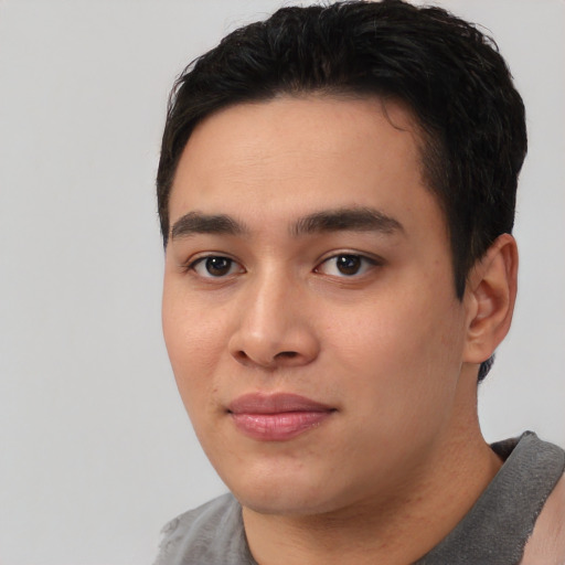 Joyful asian young-adult male with short  black hair and brown eyes