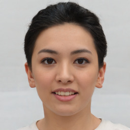 Joyful asian young-adult female with short  brown hair and brown eyes