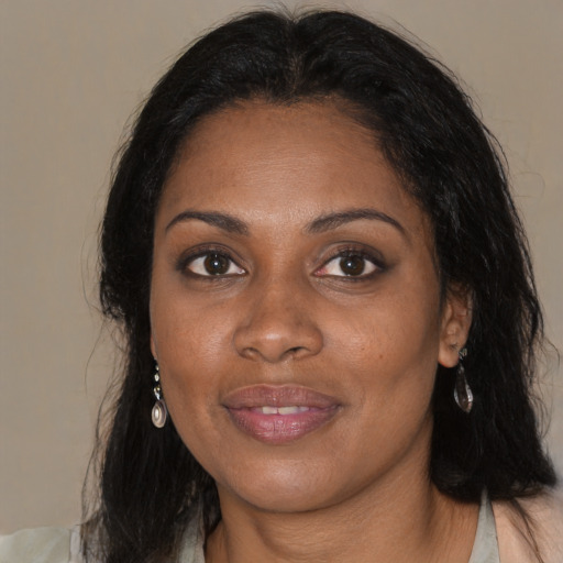 Joyful black young-adult female with medium  brown hair and brown eyes