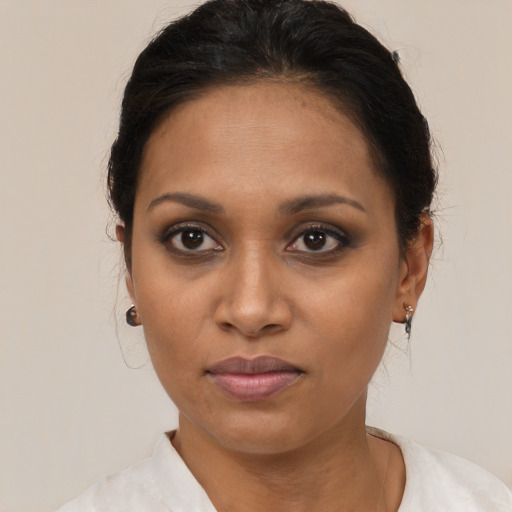 Joyful black young-adult female with medium  brown hair and brown eyes