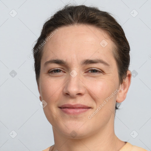 Joyful white adult female with short  brown hair and brown eyes