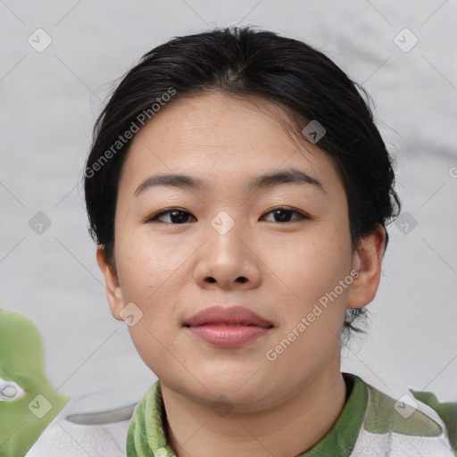 Joyful asian young-adult female with short  brown hair and brown eyes