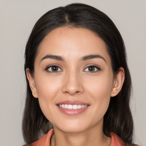 Joyful white young-adult female with long  black hair and brown eyes