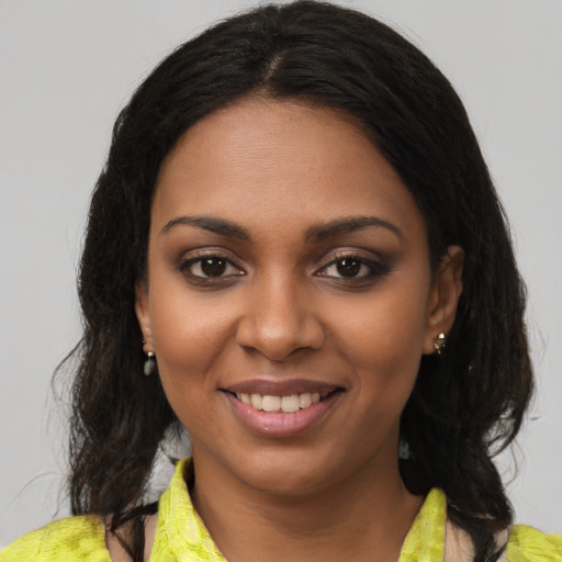 Joyful black young-adult female with medium  brown hair and brown eyes