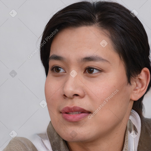 Joyful asian young-adult female with medium  brown hair and brown eyes