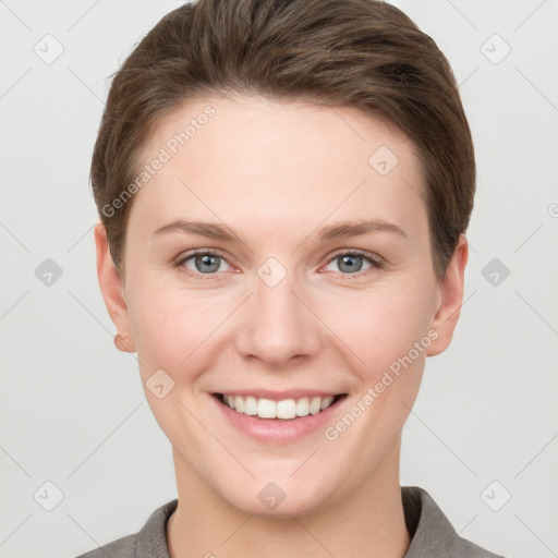 Joyful white young-adult female with short  brown hair and grey eyes