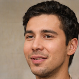 Joyful white young-adult male with short  black hair and brown eyes