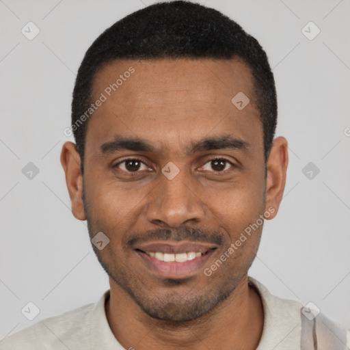 Joyful black young-adult male with short  black hair and brown eyes