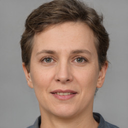 Joyful white adult female with short  brown hair and grey eyes