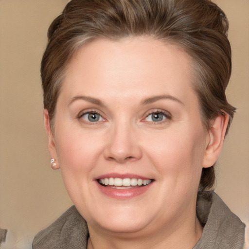 Joyful white adult female with medium  brown hair and grey eyes