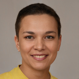 Joyful white young-adult female with short  brown hair and brown eyes