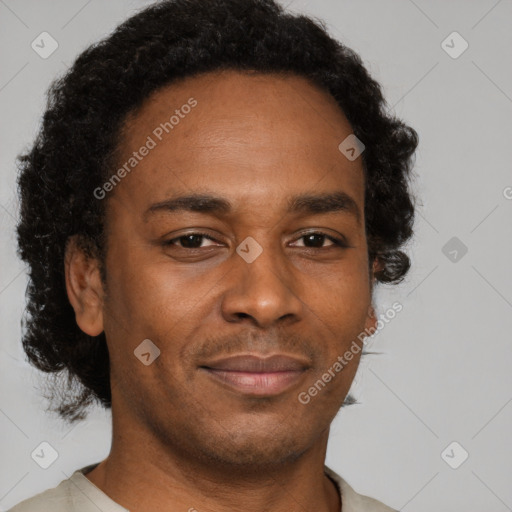 Joyful black adult male with short  brown hair and brown eyes