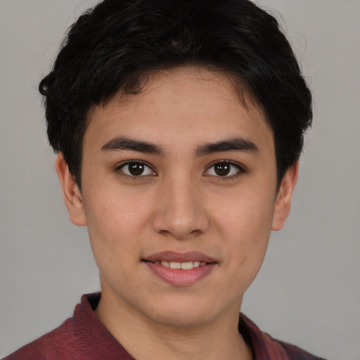 Joyful latino young-adult male with short  brown hair and brown eyes