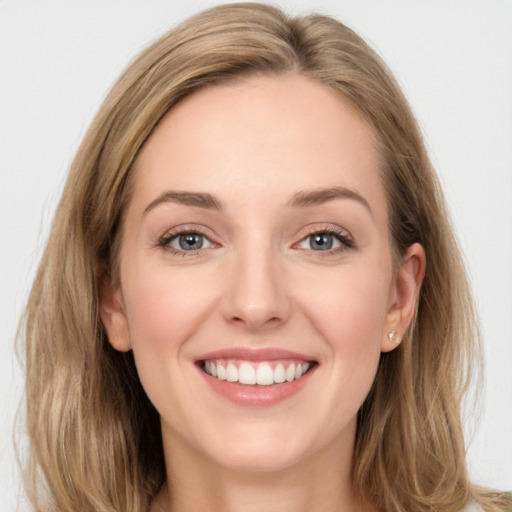 Joyful white young-adult female with long  brown hair and blue eyes