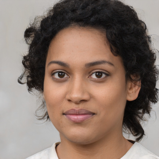 Joyful black young-adult female with medium  black hair and brown eyes
