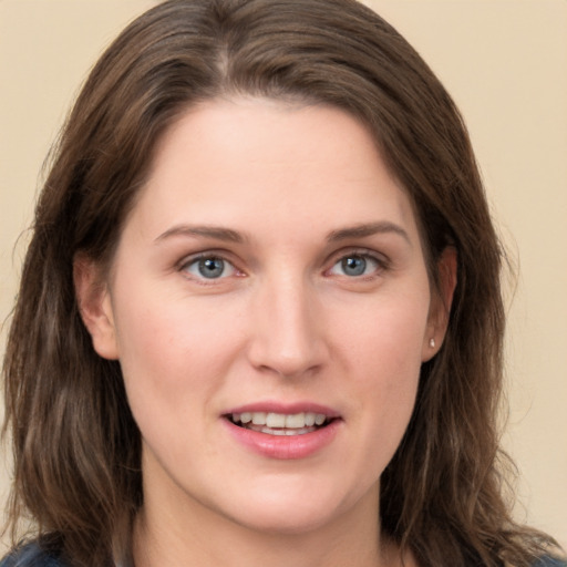 Joyful white young-adult female with long  brown hair and grey eyes