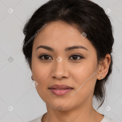 Joyful latino young-adult female with medium  brown hair and brown eyes