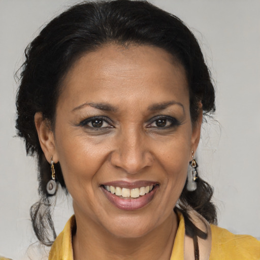 Joyful latino adult female with medium  brown hair and brown eyes