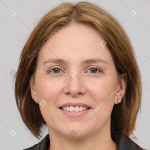 Joyful white adult female with medium  brown hair and grey eyes