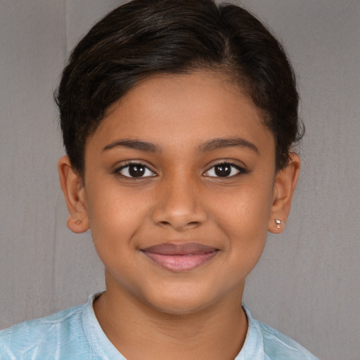 Joyful black child female with short  brown hair and brown eyes