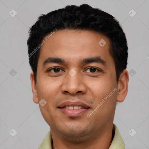 Joyful latino young-adult male with short  black hair and brown eyes