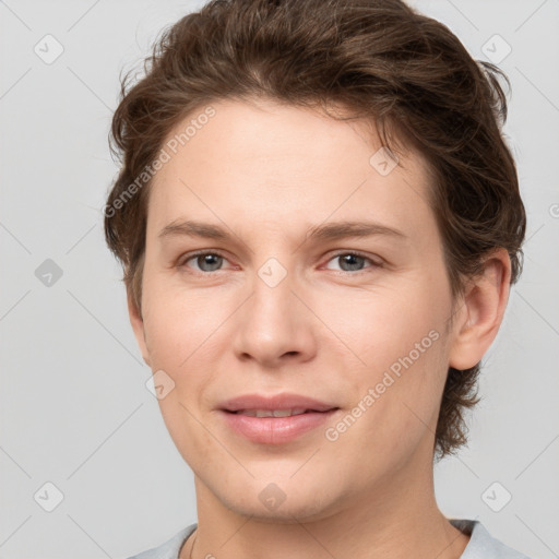 Joyful white young-adult female with short  brown hair and grey eyes