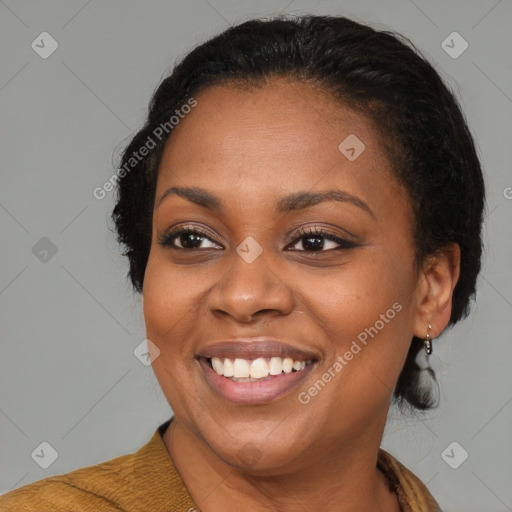 Joyful black adult female with medium  brown hair and brown eyes