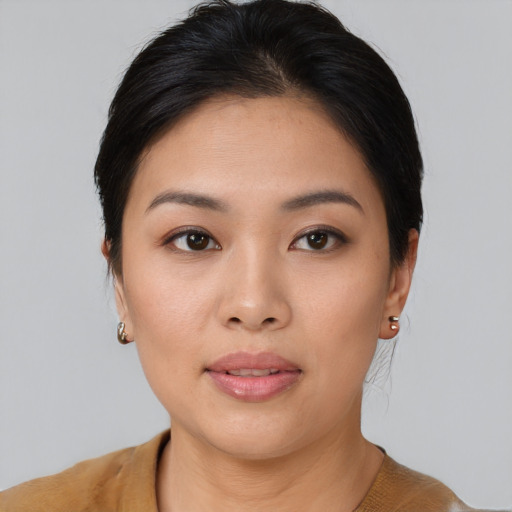 Joyful asian young-adult female with short  brown hair and brown eyes