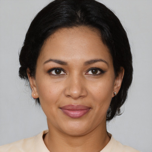 Joyful latino young-adult female with medium  black hair and brown eyes