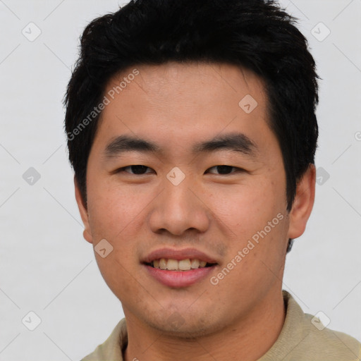 Joyful asian young-adult male with short  black hair and brown eyes