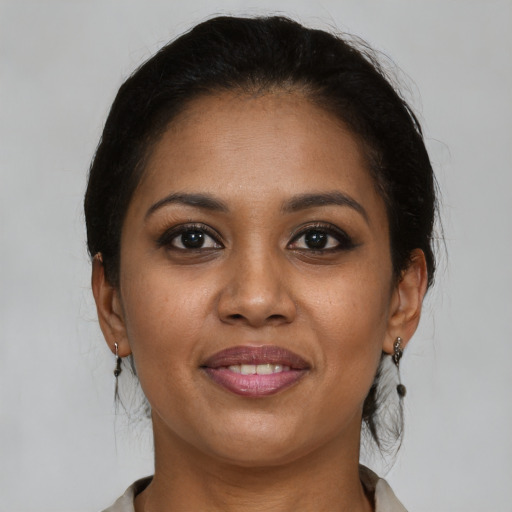 Joyful black young-adult female with medium  brown hair and brown eyes