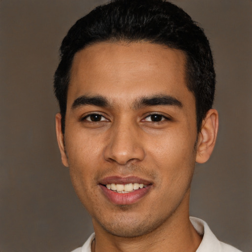 Joyful latino young-adult male with short  black hair and brown eyes