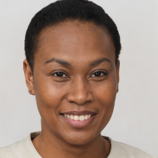 Joyful black young-adult female with short  brown hair and brown eyes