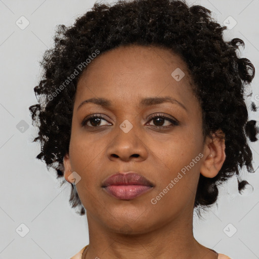 Joyful black adult female with short  brown hair and brown eyes