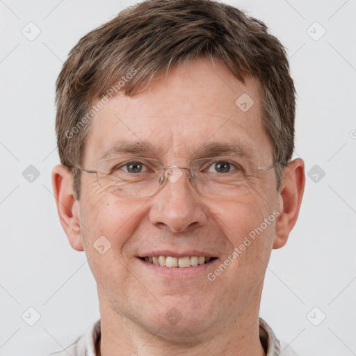 Joyful white adult male with short  brown hair and grey eyes