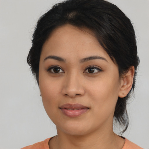 Joyful latino young-adult female with medium  brown hair and brown eyes