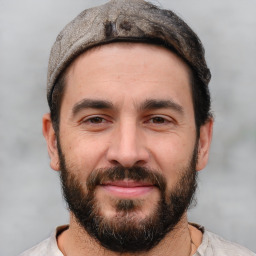 Joyful white adult male with short  black hair and brown eyes