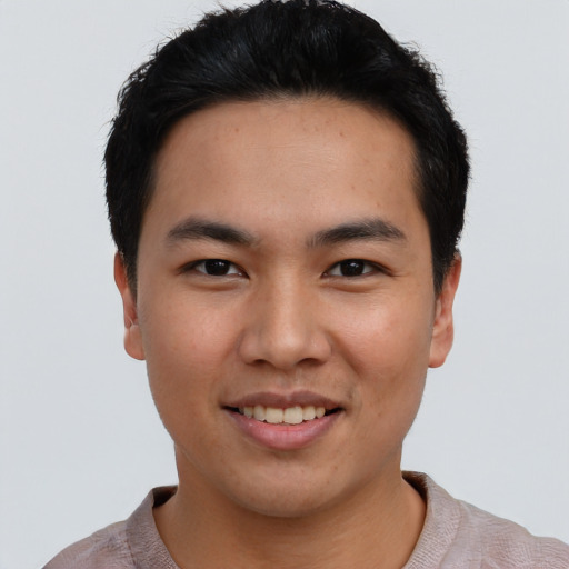 Joyful asian young-adult male with short  black hair and brown eyes