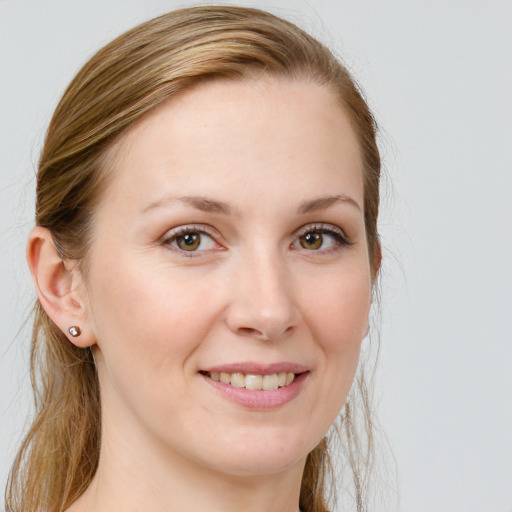 Joyful white young-adult female with long  brown hair and blue eyes