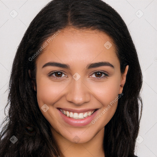 Joyful latino young-adult female with long  brown hair and brown eyes